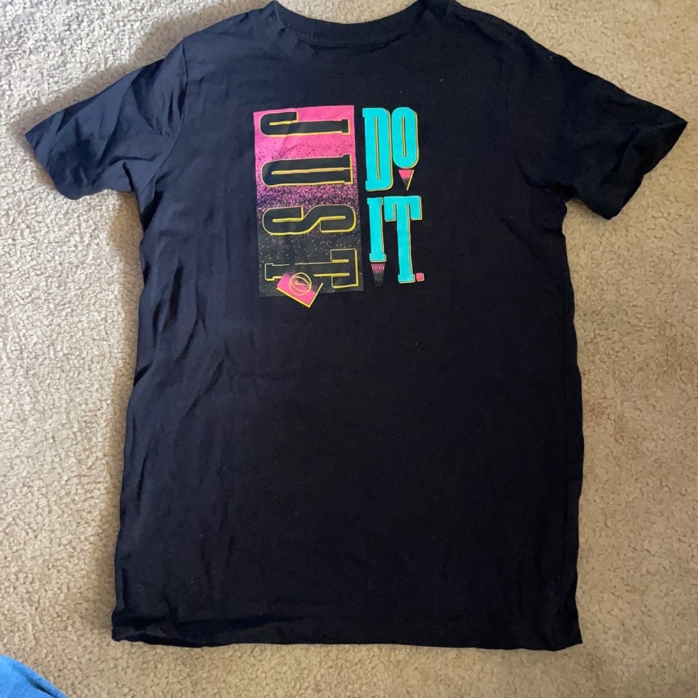Nike Just Do It. Runs small. Nike size Large. Fits more like a medium like new